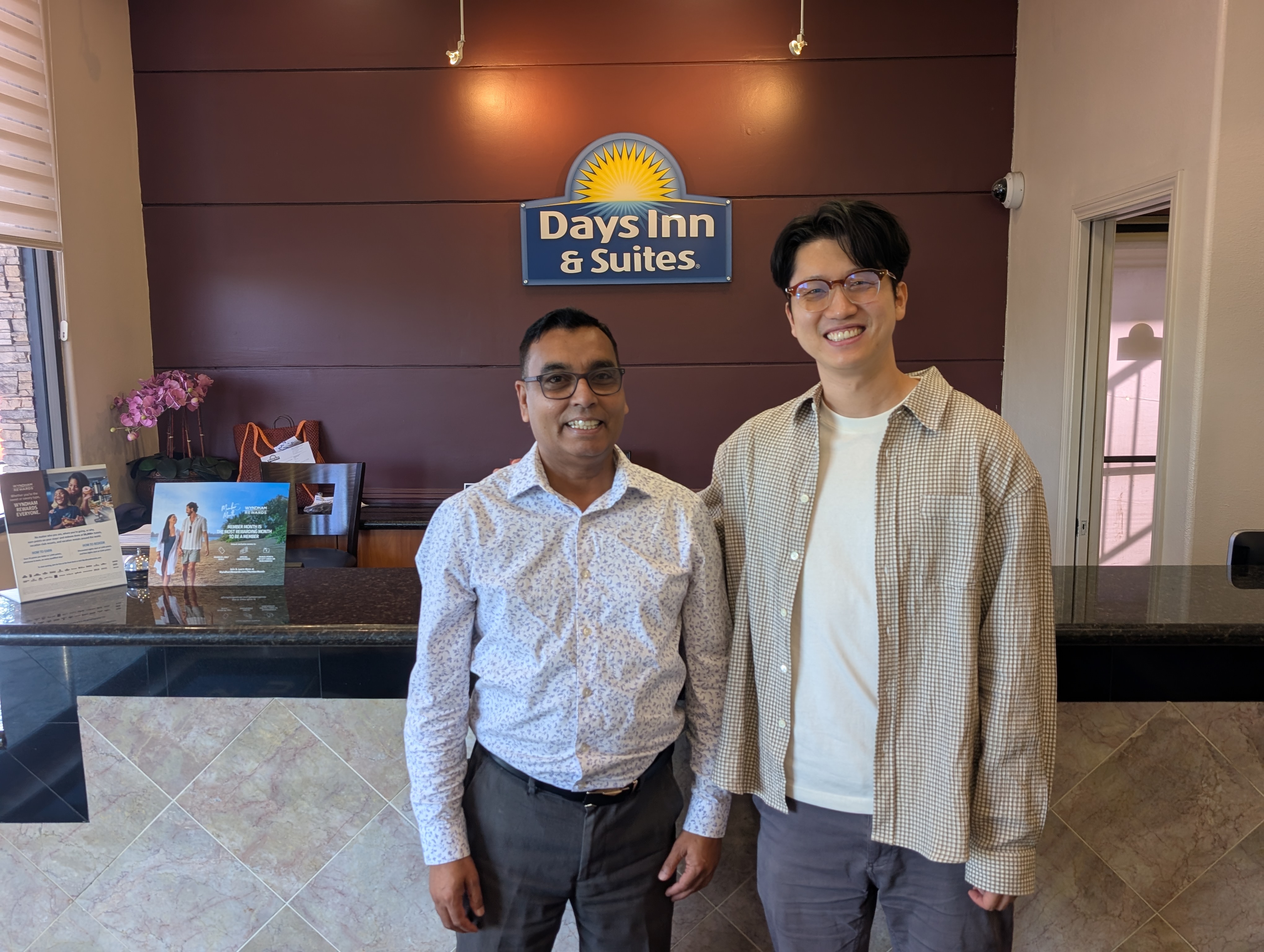 Hotel owner and a Lodgebook team member at the front desk